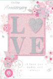 This anniversary card evokes a gentle celebration of lasting love, its design unfolding with the same tenderness as a hand-delivered bouquet in West Norwood. The centrepiece is the word LOVE, crafted in raised, softly glittering letters that invite fingertips to trace their contours. The letterforms rest on a blush-pink background that seems to glow faintly, framed by mellow whites and misty greys that keep the mood serene and intimate, like a quiet evening along Norwood Road. Within the central motif, a subtle heart shape replaces the usual circular O, shimmering with a slightly stronger silver tone that draws the eye and underscores the romantic message. Around this focal point, delicate blossoms in blush, mauve, and creamy ivory open like painted petals across the card, their edges softened as though touched with watercolour. Fine, flowing lines outline each bloom and leaf, curling into graceful vines that sweep across the design, mimicking the fluid movement of stems being arranged by a skilled florist. Tiny flourishes-curved strokes, small petals, and discreet butterflies-add a sense of light motion, as if the florals are gently swaying in a breeze drifting through local gardens. The phrases On Our Anniversary and I love you today and always are written in elegant, understated script, their loops and curves harmonising with the surrounding artwork. Throughout, subtle silver accents glimmer like dewdrops on fresh foliage, lending a quiet touch of festivity. The overall impression is of a softly spoken, profoundly heartfelt keepsake, perfect to accompany anniversary flowers delivered around West Norwood to honour a story of shared days, quiet support, and enduring romance.